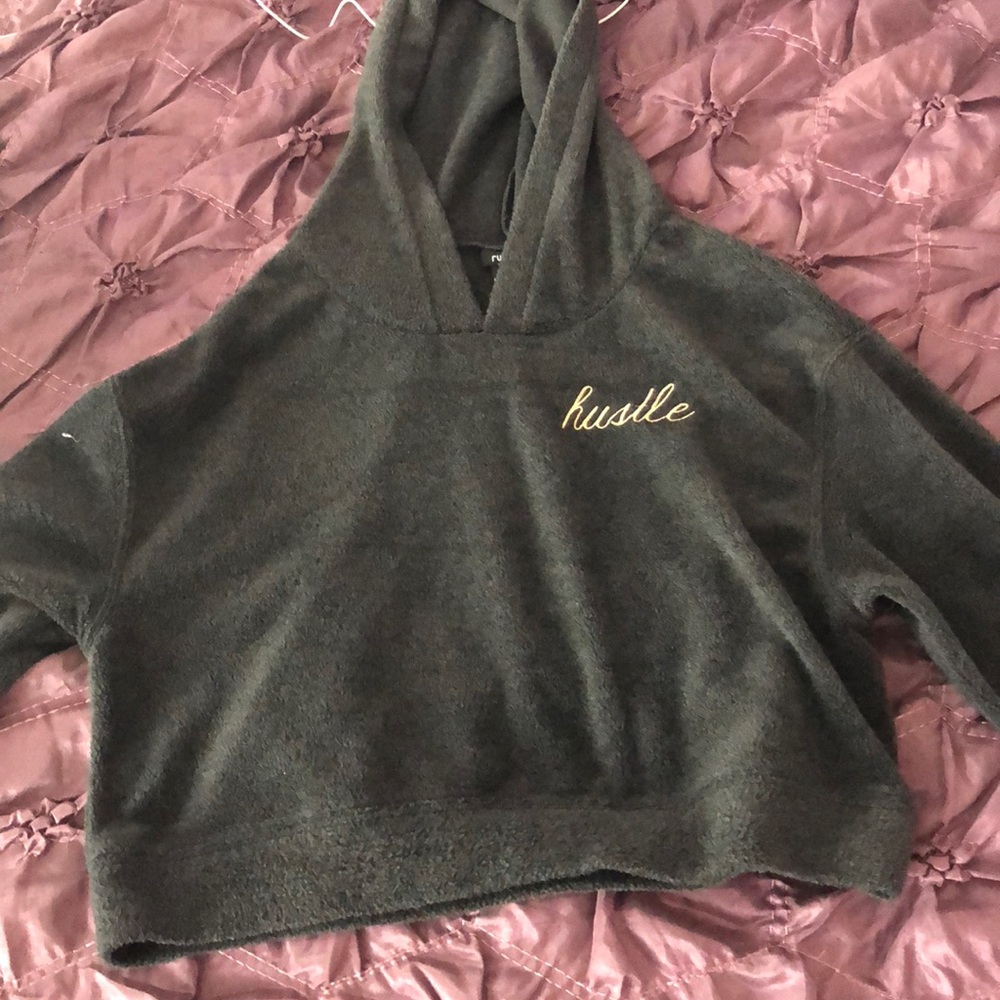 A grey sweatshirt with gold letters